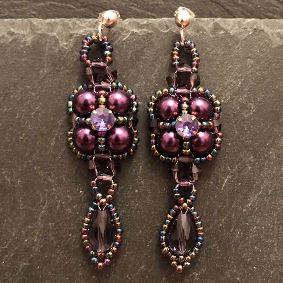 Thundercloud earrings made from purple seed beads, pearls and crystals.