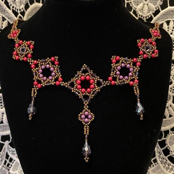 Tudor necklace made from red and purple pearls and purple crystals.