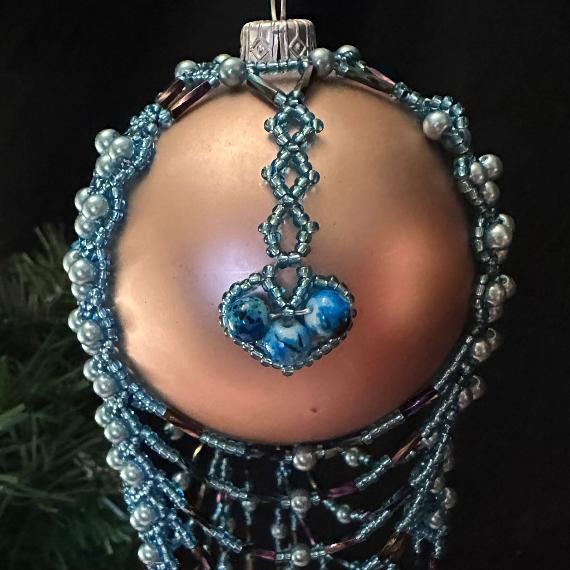 Bauble made with blue beads on a gold bauble Christmas tree ornament.