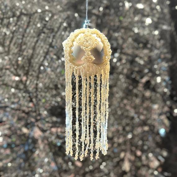 White bauble on a glittery background.